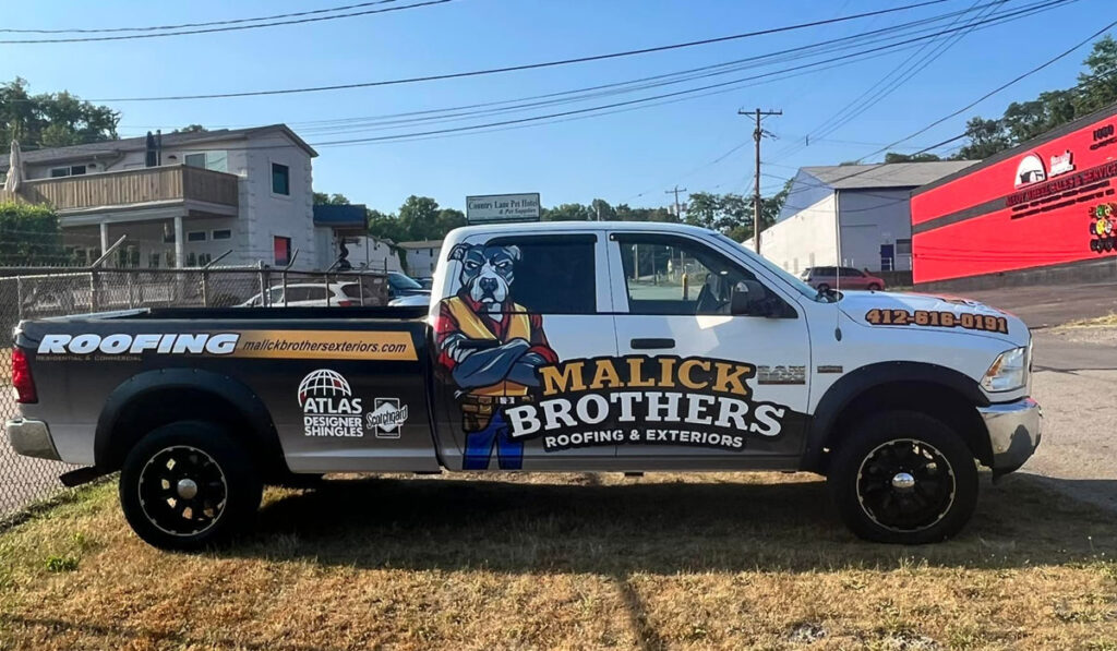 Malick Brothers Exteriors branded truck parked outside, featuring roofing services and contact information, emphasizing local expertise in Pittsburgh roofing.