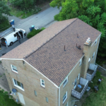 Roofing installation on a residential building in Pittsburgh, showcasing quality workmanship and attention to detail.