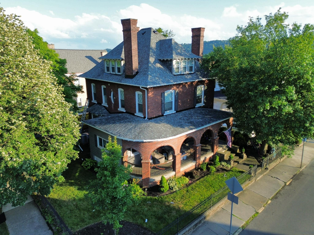 Historical house with a newly installed roof by Malick Brothers Exteriors in Blawnox, showcasing expert craftsmanship and high-quality materials.