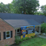 Roofing project by Malick Brothers Exteriors featuring a brick house with a newly installed roof and a promotional banner highlighting roofing services for historical properties in Pittsburgh.