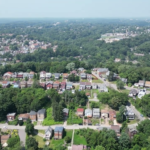 Aerial view of residential neighborhood in Tarentum, showcasing houses and greenery, relevant to gutter maintenance and home protection discussions.