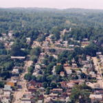 Aerial view of a residential neighborhood in Tarentum, Pennsylvania, showcasing homes surrounded by trees and streets, relevant to gutter maintenance and home exterior solutions.