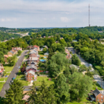 Aerial view of Stanton Heights, Pittsburgh, showcasing residential homes surrounded by a dense tree canopy, illustrating the impact of trees on roof maintenance.