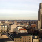 Pittsburgh skyline view featuring various buildings and rooftops, relevant to winter roof maintenance tips for homeowners in Point Breeze.
