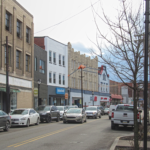 Street view of Mount Washington, featuring various buildings and parked cars, relevant for local roofing maintenance tips for homeowners.