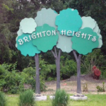 Brighton Heights sign featuring stylized trees and the neighborhood name, representing local community identity in Pittsburgh.