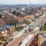 Aerial view of a residential neighborhood in Allentown, featuring houses, a tram line, and parked cars, highlighting local infrastructure relevant for roofing projects.