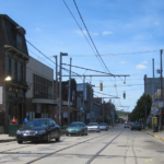 Street view of Beechview with parked cars, buildings, and overhead power lines, illustrating the community context for winter roof maintenance tips.