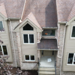 Residential building featuring Atlas Pinnacle® Pristine Shingles in Burnt Hickory, showcasing elegant design and durable roofing solution.