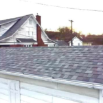 Roofing installation featuring asphalt shingles on a residential home, emphasizing proper roofing techniques and materials for longevity and protection against damage.