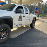 Malick Brothers Exteriors branded truck parked at a gas station, showcasing the company's commitment to providing roofing services in Pittsburgh.
