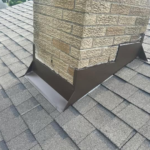 Chimney flashing installed on a roof, ensuring protection against water damage and highlighting the importance of roof maintenance by Malick Brothers Exteriors in Pittsburgh.