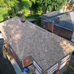Aerial view of a residential roof showcasing asphalt shingles, highlighting roof condition and design, relevant to roof repair and replacement considerations in Pittsburgh.