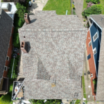 Aerial view of a residential roof showcasing quality shingles, emphasizing the importance of reliable roofing services from Malick Brothers Exteriors in Pittsburgh.