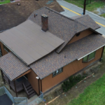 Pinnacle® Sun shingles on a residential roof, showcasing a blend of elegance and durability, with a brown color scheme enhancing the home's exterior aesthetics.