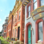 Historic rowhouses in Pittsburgh showcasing vibrant brick facades and intricate architectural details, emphasizing the charm and artistry of Tudor-style homes.