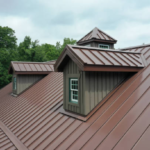 Roof featuring a brown metal design with dormer windows, surrounded by greenery, illustrating commercial roofing solutions for winter maintenance in Pittsburgh.