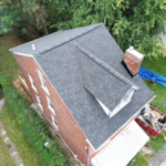 Aerial view of a residential roof showcasing asphalt shingles, surrounded by trees and a backyard, relevant to roofing project considerations by Malick Brothers Exteriors.