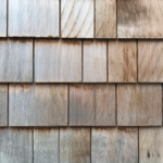 Wooden shake roof shingles showcasing natural texture and color variations, relevant to discussions on roofing materials and maintenance by Malick Brothers Exteriors.