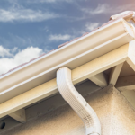 Gutter system installation on a residential roof, showcasing proper drainage and roofing quality for long-term home safety.