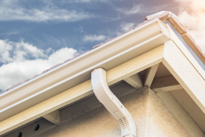 Gutter system featuring a micro-mesh guard and downspout, emphasizing effective water drainage and debris protection, relevant to gutter guard evaluations.