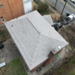 Aerial view of a residential roof featuring Pinnacle® Pristine Shingles in Summer Storm color, showcasing the roof's design and texture, highlighting its aesthetic appeal and durability for exterior transformation by Malick Brothers Exteriors.