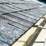 Close-up of asphalt shingles on a roof, highlighting the texture and condition relevant to homeowner insurance coverage for roof leaks.