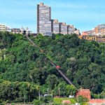 Scenic view of Upper St. Clair's hillside with urban buildings and a funicular railway, highlighting the area's blend of nature and modern architecture.