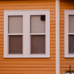 Insulated siding on a Pittsburgh home featuring two white-framed windows, emphasizing energy efficiency and aesthetic appeal for winter resilience.