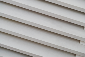 Vinyl siding installation showing interlocking panels, emphasizing proper alignment and secure locking system for effective weather protection.