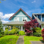 Charming urban home in South Side Flats with a blue exterior, landscaped garden, and vibrant foliage, symbolizing elegance and modern architectural design.