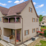 Modern home exterior in Fineview, Pittsburgh featuring elegant siding, architectural details, and a welcoming porch, reflecting current roofing and siding trends.