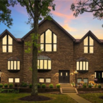 Victorian-style home with modern siding, showcasing a blend of historical charm and contemporary design, surrounded by lush greenery and evening light, emphasizing exterior enhancements in Bloomfield.