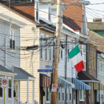 Historic homes in Polish Hill, Pittsburgh, featuring traditional architecture and an Italian flag, symbolizing cultural heritage and community pride.