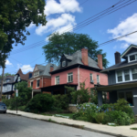 Houses in Beechview with varied architectural styles and roofs, showcasing residential neighborhood and landscaping, relevant to winter roofing maintenance tips.