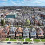 Aerial view of East Liberty rooftops showcasing a blend of traditional and modern architectural styles, reflecting the neighborhood's innovative spirit and community heritage.