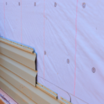 Commercial roofing installation process showing layered siding components and moisture barrier, relevant to Pittsburgh roofing maintenance and exterior services.