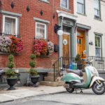 Charming residential street in Moon Township featuring a vintage scooter, colorful flower boxes, and well-maintained steps, reflecting a community-focused atmosphere.