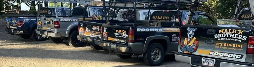 Malick Brothers Exteriors branded trucks lined up, showcasing roofing services and contact information, emphasizing professional gutter and roofing solutions for homeowners in Pittsburgh.