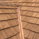 Wood shake roofing system showcasing textured shingles and a central ridge, relevant to roofing material discussions for residential and commercial properties.