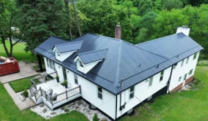 Metal roof installation on a residential home in Pittsburgh, showcasing durability and modern aesthetics, surrounded by greenery.
