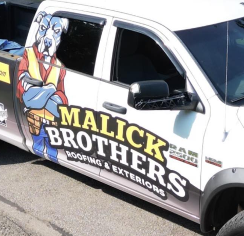 Malick Brothers Exteriors branded truck featuring a cartoon dog mascot, showcasing roofing and exterior services in Pittsburgh.