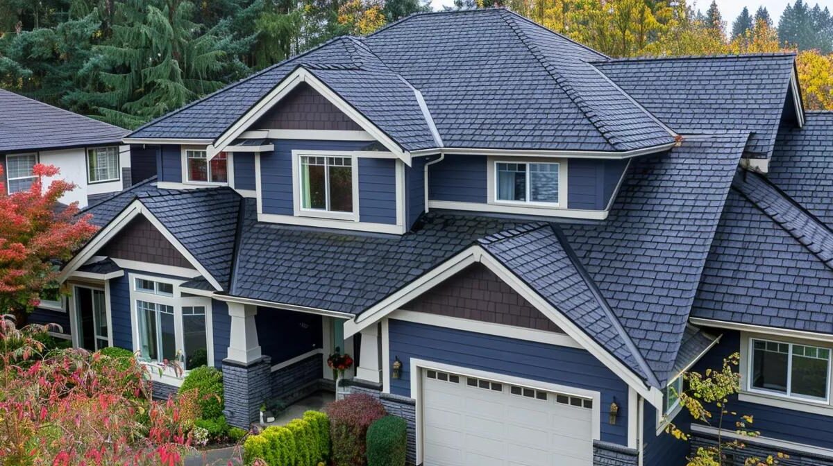 Aerial view of a modern home showcasing a dark blue roof, highlighting energy-efficient roofing options suitable for Pittsburgh neighborhoods.