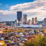 Pittsburgh skyline showcasing residential rooftops and urban architecture, reflecting local roofing trends and home improvement insights.