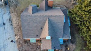 Aerial view of a residential roof featuring architectural shingles, highlighting the structure's design and potential roofing needs for Pittsburgh homeowners.
