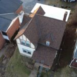 Aerial view of a residential home showcasing a newly installed roof, highlighting quality craftsmanship and roofing materials, relevant to Malick Brothers Exteriors' roofing services in Pittsburgh.