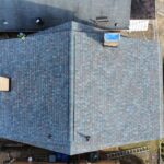Aerial view of a recently installed blue shingle roof, showcasing the roof's structure and quality, relevant to roofing services in Pittsburgh.