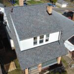 Aerial view of a residential roof in Pittsburgh, showcasing new shingles and a well-maintained exterior, emphasizing the importance of roof inspections for homebuyers.