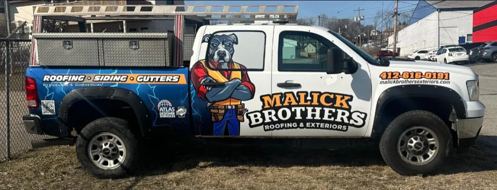 Malick Brothers Exteriors branded truck with dog mascot, showcasing services for roofing, siding, and gutters, parked on a Pennsylvania street.