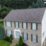 Pittsburgh home with newly installed roof and stone exterior, showcasing quality home improvement by Malick Brothers Exteriors.